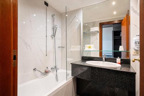 a bathroom with a sink and a shower and a tub at Ferretti Hotel Catullo Verona in San Martino Buon Albergo