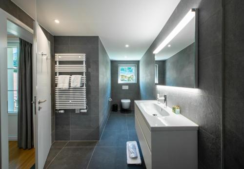 a bathroom with a white sink and a mirror at Chalet Mittaghorn Apt 7 in Wengen