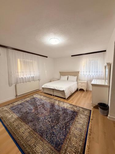 a bedroom with a bed and a rug at Vila Noor Sarajevo in Sarajevo