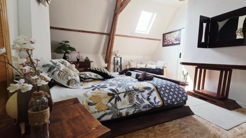 a bedroom with a bed with pillows on it at Domaine Les Tourelles - La petite maison in Caffiers