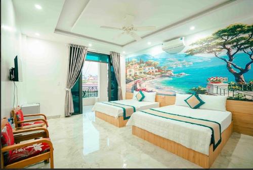 a bedroom with two beds and a painting on the wall at Chinh Thuỷ Hotel in Sầm Sơn