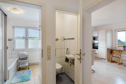 a bathroom with a toilet and a sink at Haus Am Schroffen in Ottenhöfen