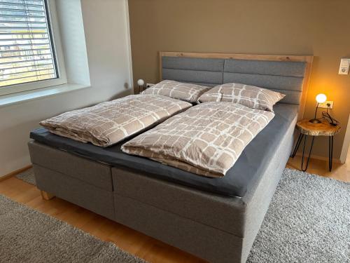 a bed with two pillows on it in a bedroom at Bergzauber in Bludenz
