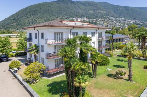 an aerial view of a house with palm trees at Villa Delta - Parkhotel Delta in Ascona