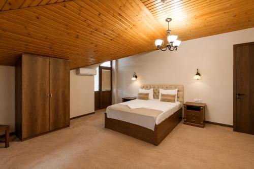 a bedroom with a bed and a wooden ceiling at Hotel Imperial House in Tbilisi City