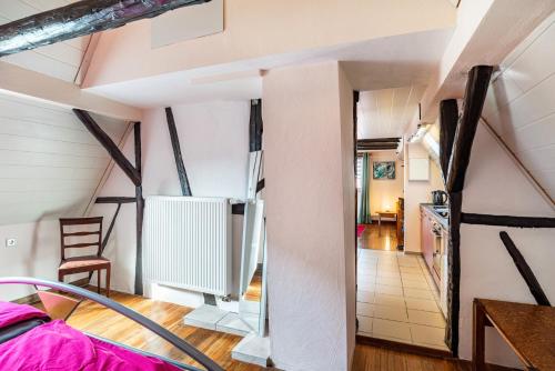 a room with a staircase leading to a kitchen and a living room at Ferienwohnung Blaues Haus in Ubstadt-Weiher