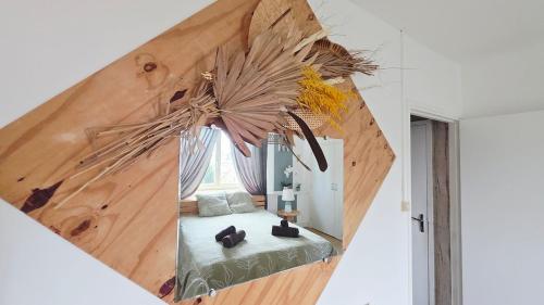 a room with a bed with a large wooden wall at Domaine Les Tourelles - Gîte 4 in Caffiers