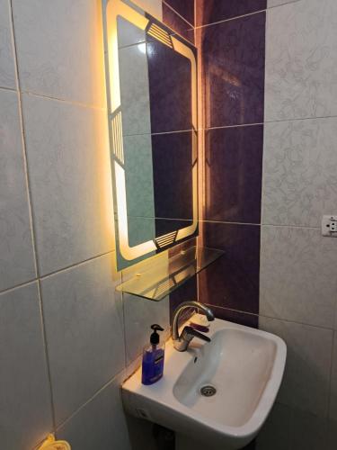 a bathroom with a sink and a mirror at شقق وهوستل قصر الشباب للمصريين و المقيمين فقط Youth Palace Hostel & Apartments for Egyptians & Residents Only in Alexandria