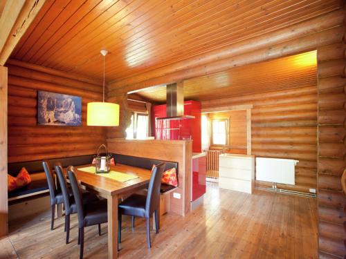a dining room with wooden walls and a table and chairs at Chalet in the Wilder Kaiser ski area in Tyrol in Wörgl