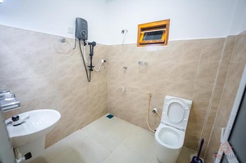 a bathroom with a toilet and a sink at Zen Nallur in Jaffna