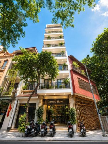 a group of motorcycles parked in front of a building at Hanoi Luxury Hotel - Old Quarter in Hanoi