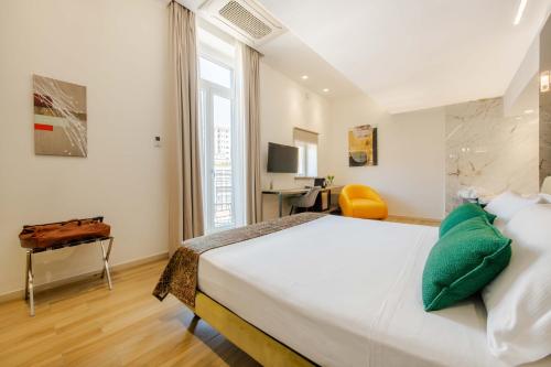 a bedroom with a large bed and a desk at Municipio Luxury Suite in Naples
