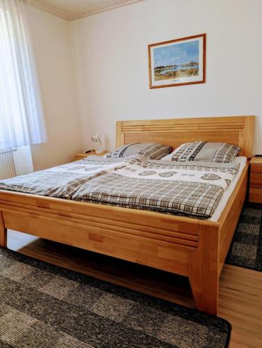 a bedroom with a wooden bed in a room at Ferienwohnung Hasenhorn in Todtnau