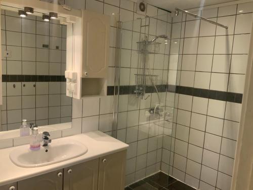 a bathroom with a sink and a glass shower at Ørntua in Rekdal