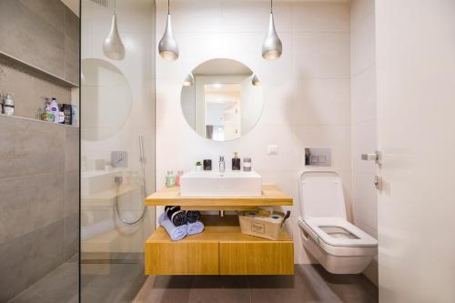 a bathroom with a sink and a toilet at The Address Bucharest in Bucharest