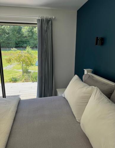 a bedroom with a bed with a large window at Athol Country Bed & Breakfast - Entire Guest Wing in Athol