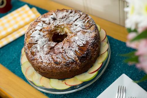 a cake sitting on a plate on a table at Old Harbor Inn in Chatham