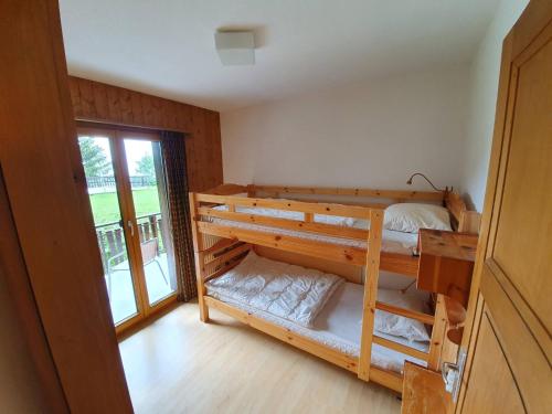 a room with two bunk beds and a window at Dent-Blanche in Les Collons