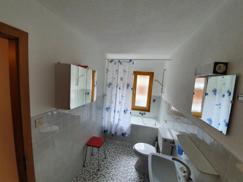 a bathroom with a toilet and a sink at Dent-Blanche in Les Collons