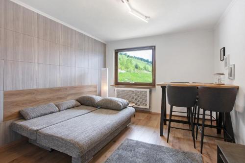 a living room with a couch and a table at Haus Tannenberg in Todtnau