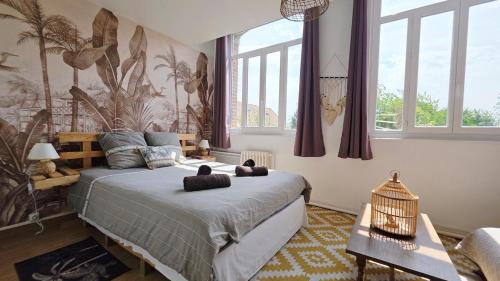a bedroom with a bed with two stuffed animals on it at Domaine Les Tourelles - Gîte 3 in Caffiers