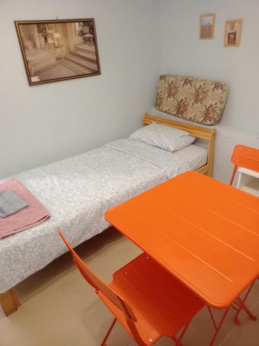 a small room with a bed and a table at Christos in Asvestokhórion