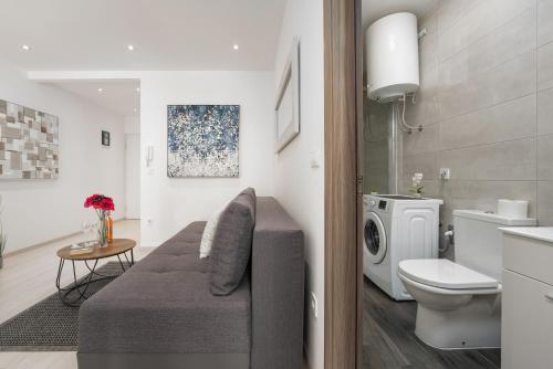 a bathroom with a couch and a washing machine at SILVER luxury in Pula