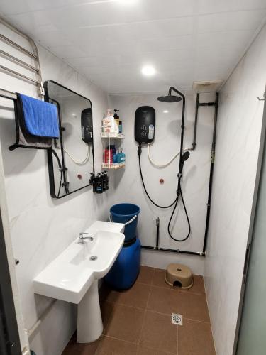 a bathroom with a sink and a toilet at Arlyn's Homestay in Sandakan