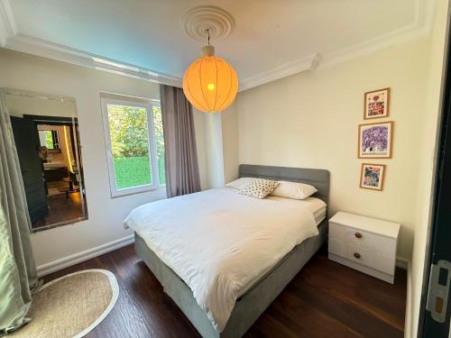 a bedroom with a bed and a large window at Luxury villa in mountain in Geyikbayırı