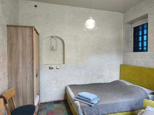 a bedroom with a bed with towels on it at Номер в доме у моря с бассейном in Odesa