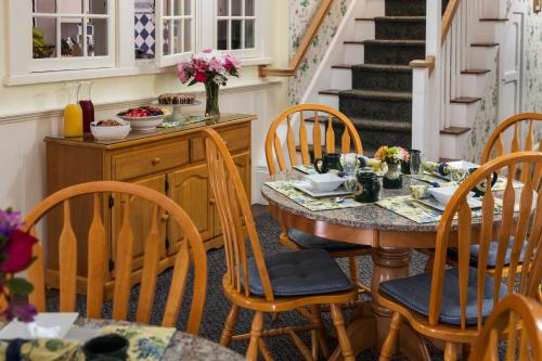 a dining room with a table and chairs at Old Harbor Inn in Chatham