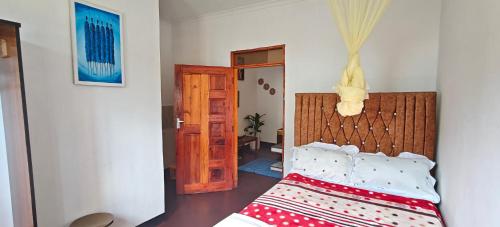 a bedroom with a bed in a room at Dans place in Moshi