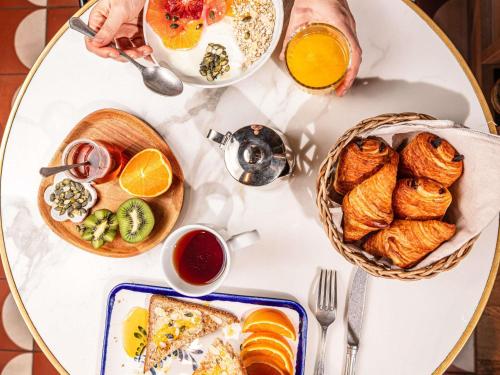 a white table with breakfast foods on it at ibis Styles Arcachon Gujan Mestras in Gujan-Mestras