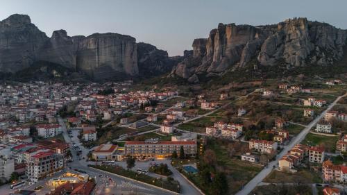 an aerial view of a city with mountains in the background at Divani Meteora Hotel in Kalabaka