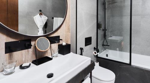 a bathroom with a white sink and a mirror at Barcelo Business Bay Dubai in Dubai