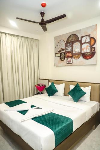 a bedroom with two beds with green and white pillows at Madhu's Palace in Amarnāth