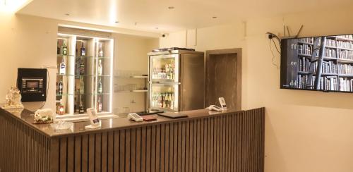 a restaurant with a counter with a refrigerator at Madhu's Palace in Amarnāth