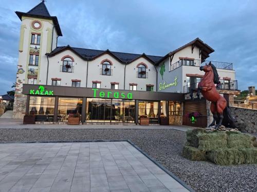 a large building with a statue in front of it at Hotel Kazak Club in Chişinău