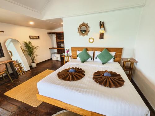 a bedroom with a bed with two pillows on it at Ocean Vibes Resort in Thong Sala