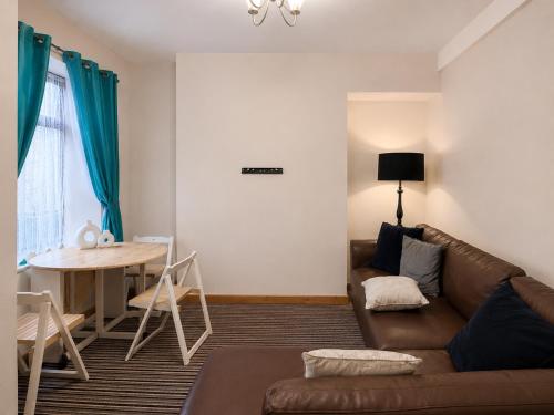a living room with a couch and a table at 54 - Room 4 - Very spacious in Swansea