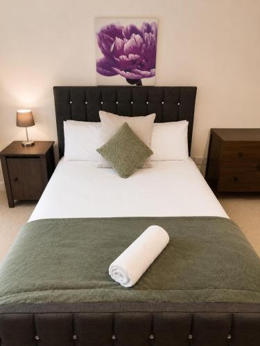 a large bed with a pillow on top of it at 54 - Room 4 - Very spacious in Swansea
