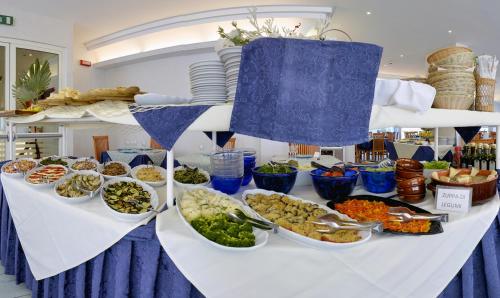 a buffet with bowls of food on a table at Hotel Margareth in Riccione