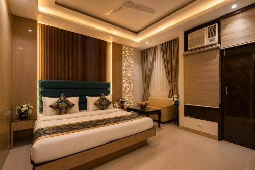 a bedroom with a large bed in a room at Hotel Baba Deluxe near New Delhi Railway Station and City Center -By RCG Hotels in New Delhi