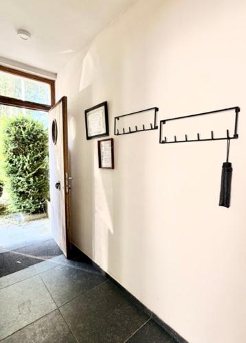 a hallway with a door and a room with a window at De Blinker in Damme