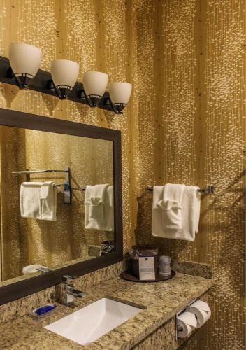a bathroom with a sink and a mirror at Best Western Plus Moosomin Hotel in Moosomin