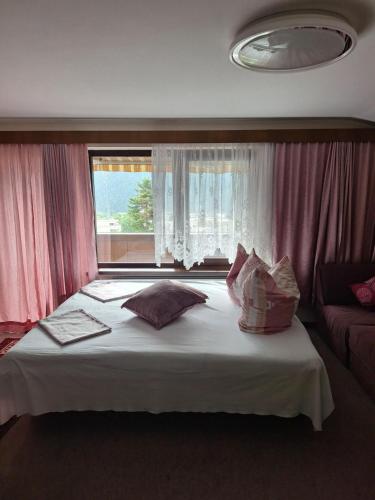 a large bed in a room with a window at Bed & Breakfast Simone in Imst
