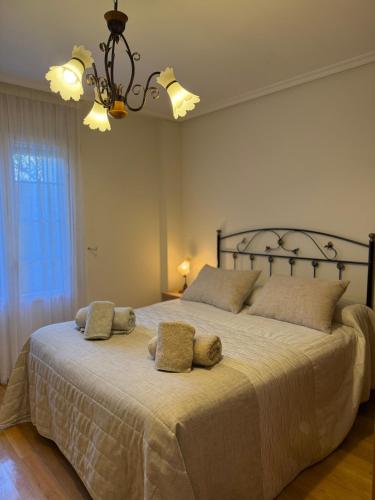 a bedroom with a large bed with two pillows on it at El abrazo de La Yecla in Espinosa de Cervera