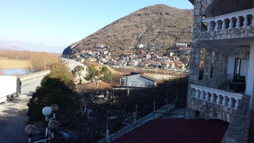 a view of a town on a hill with a mountain at Guesthouse Mala Venecija in Virpazar