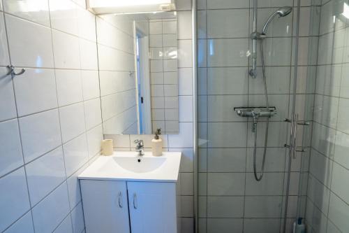 a bathroom with a sink and a shower at Authentic rorbu by the sea in Stamsund