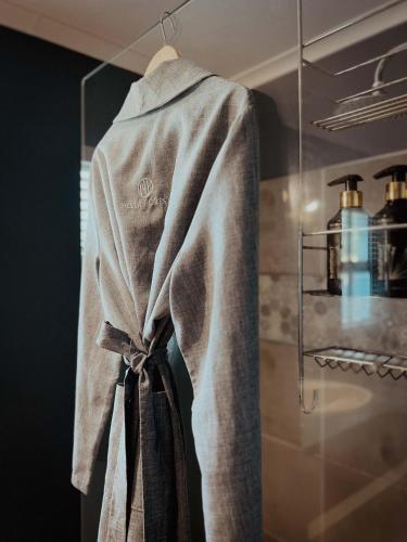 a robe hanging on a rack in a kitchen at Silver Forest Boutique Hotel, Spa, Restaurant & Bar in Somerset West